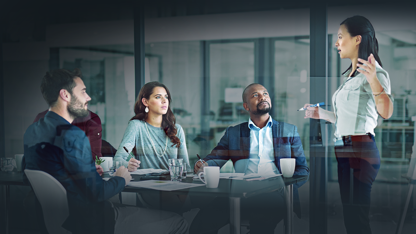 A groups of workers listening to female boss.